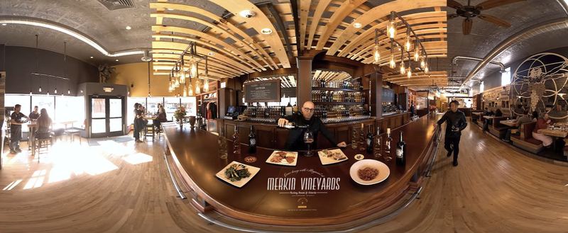 A 360 degree frame of the Merkin Vineyards tasting room with a man pouring wine at the bar